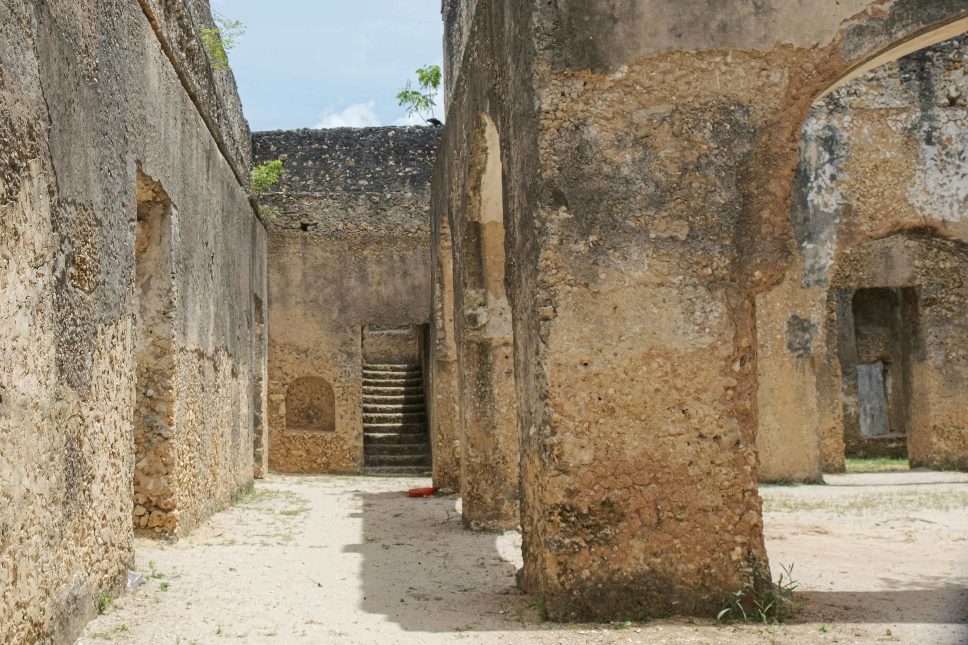 Coral-stone arches and a worn stairway in Zanzibar's Stone Town.